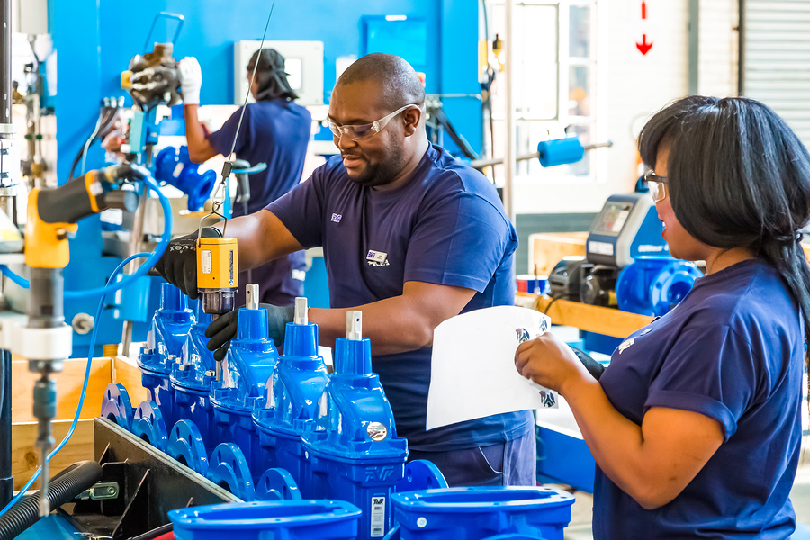 Workers in an industrial valve manufacturing factory