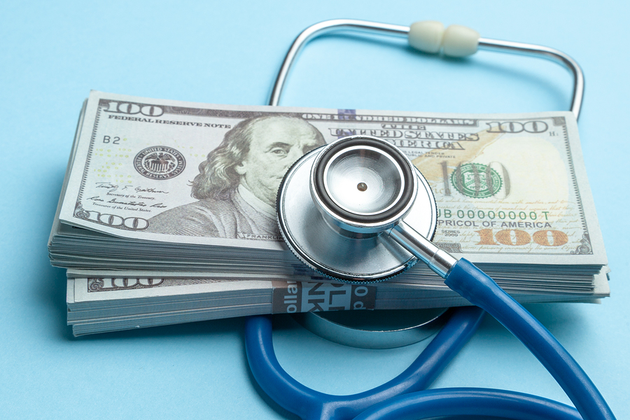 Stethoscope on stack of U.S. $100 bills