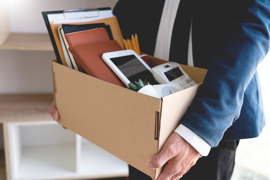 Man carrying box of work belongings