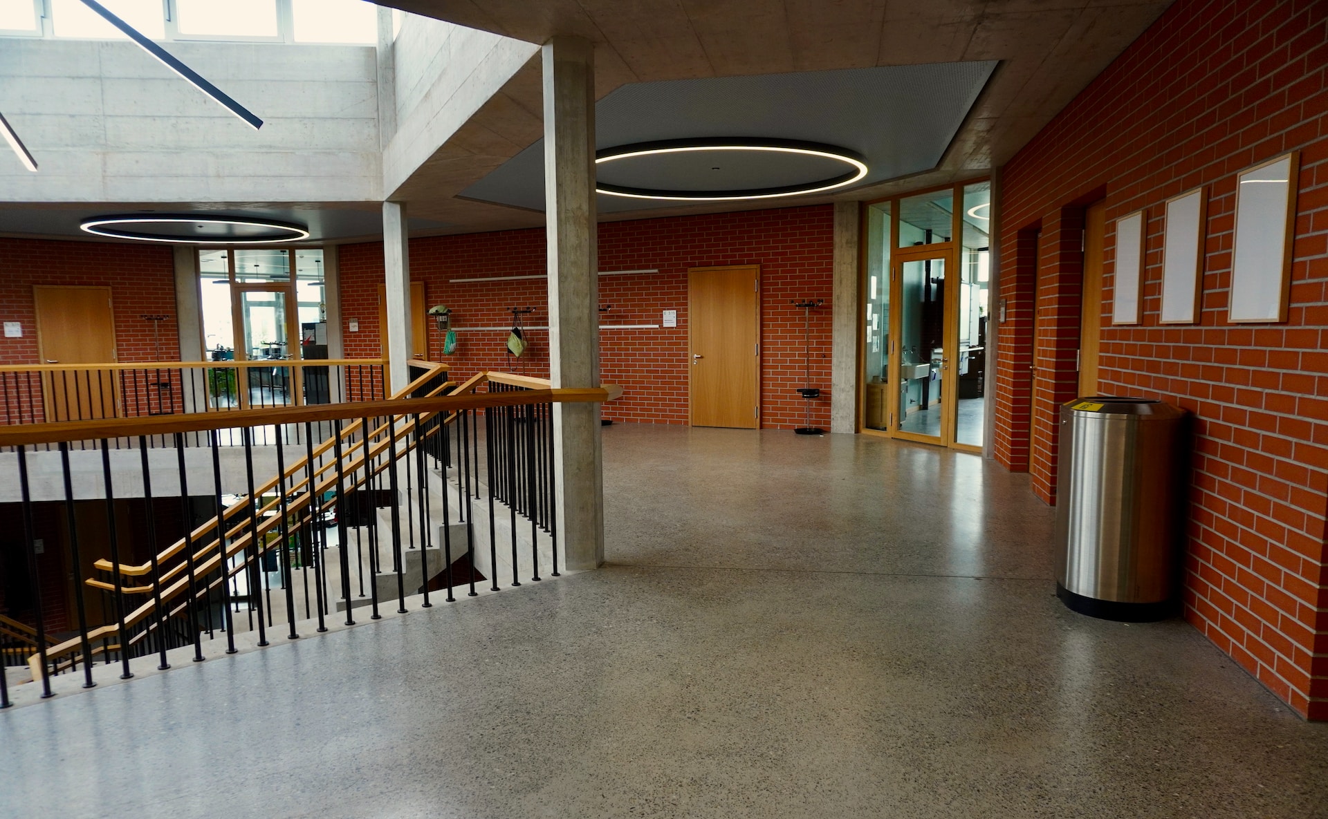 A modern-looking empty school interior with natural light and a staircase