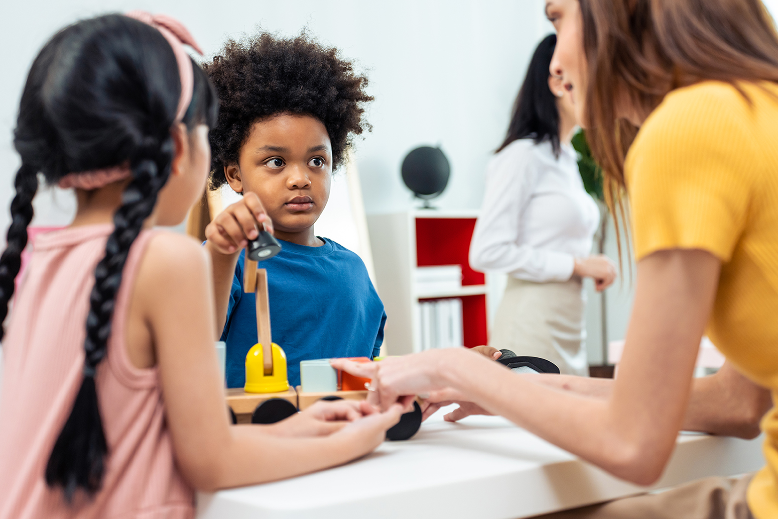 Day care teacher works with children 