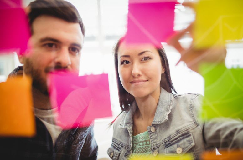 Workers examine sticky notes