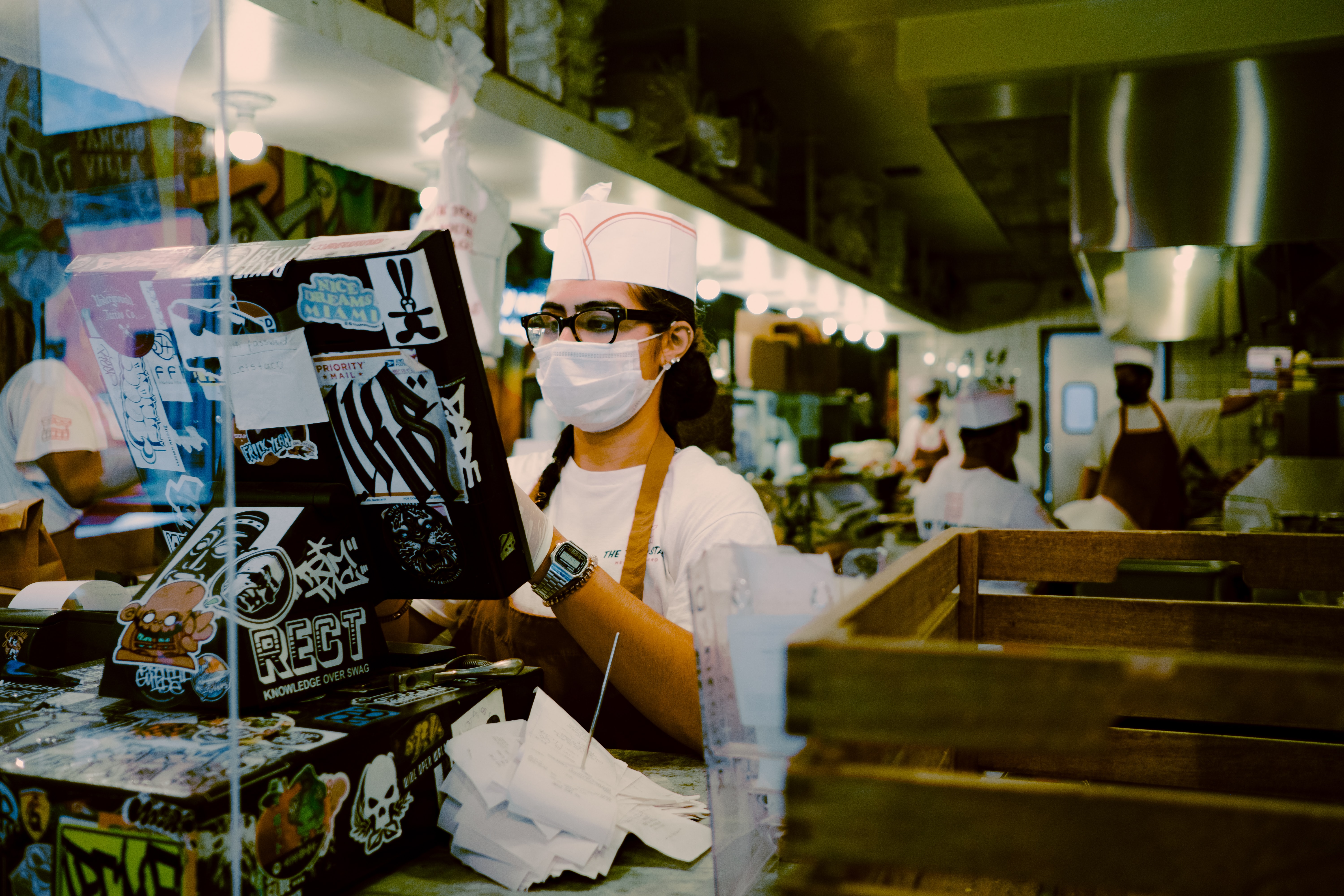 Server wearing COVID mask at register