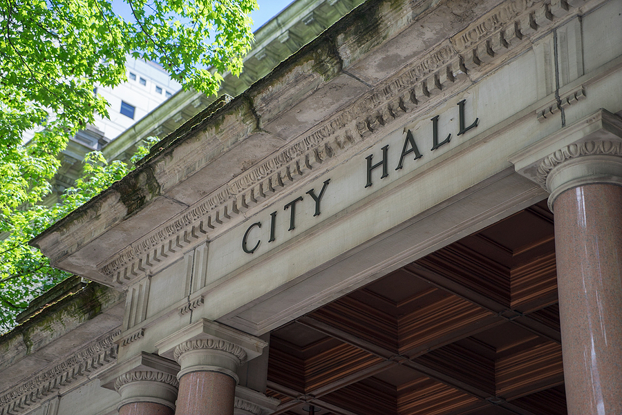 City hall exterior with the words "city hall" above entryway
