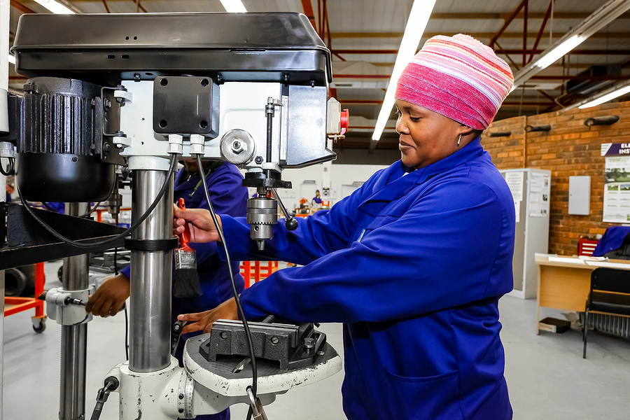 Woman works in machine shop