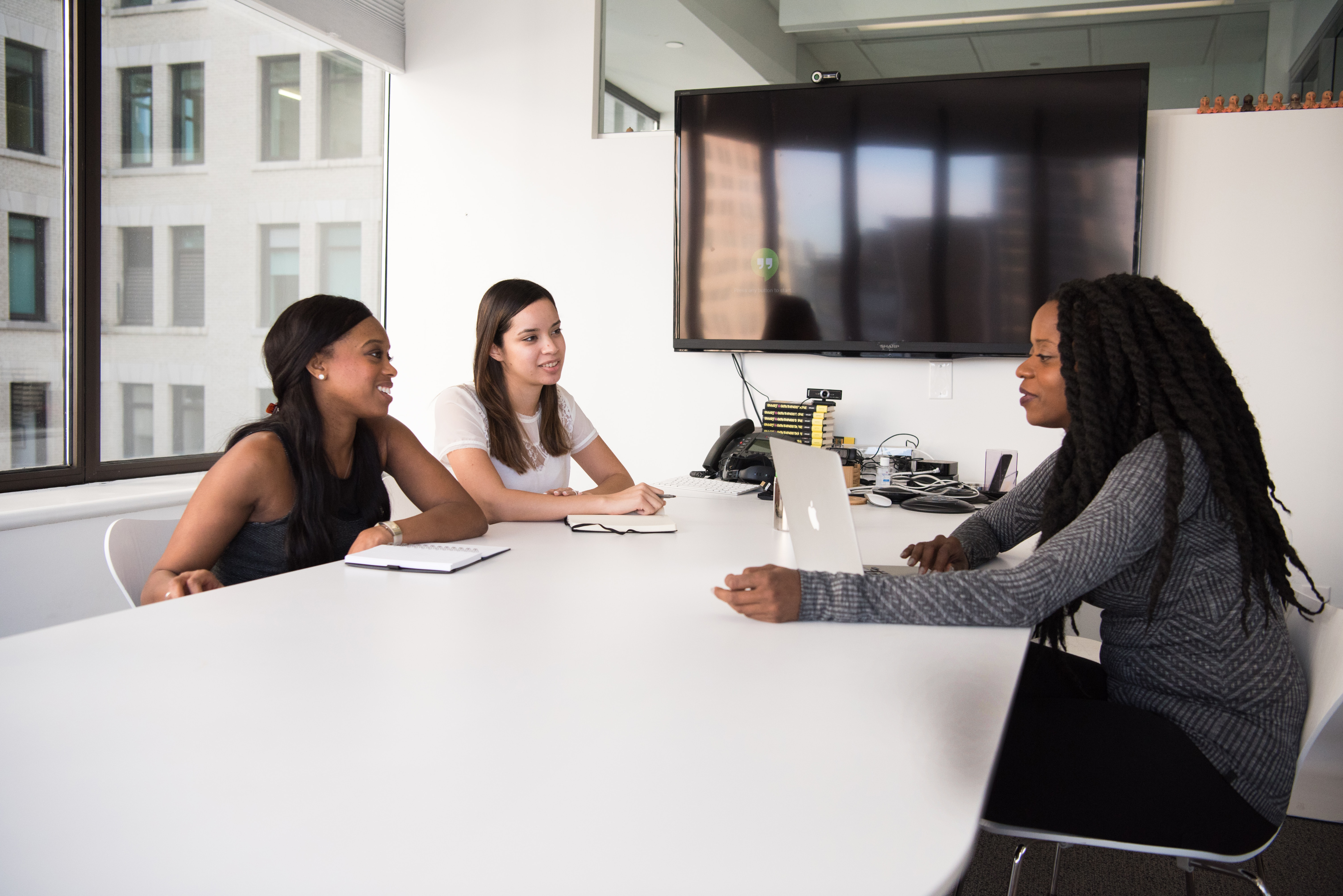 Three business women at table hiring discussion