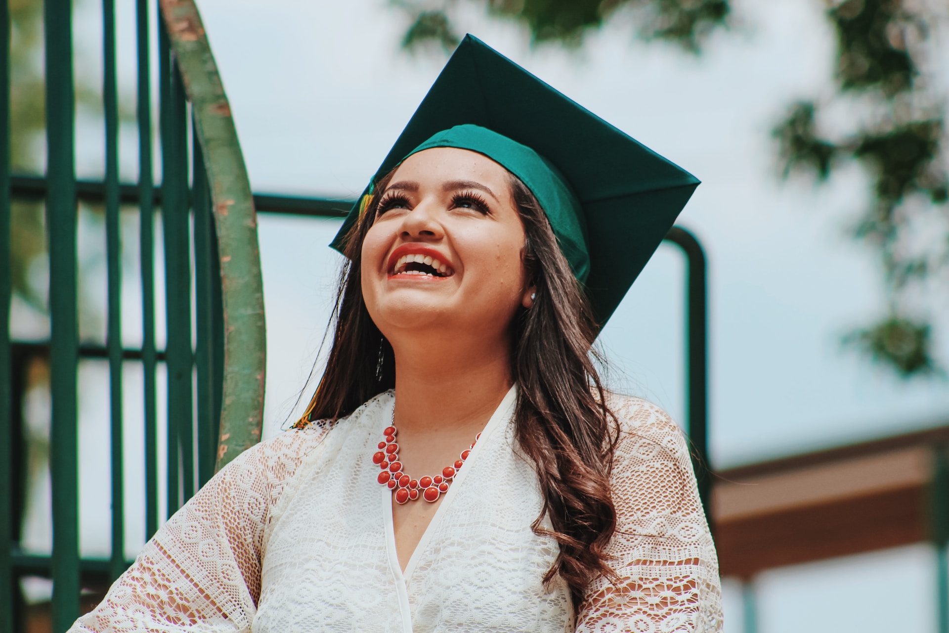 Graduation image, woman in green mortarboard hat