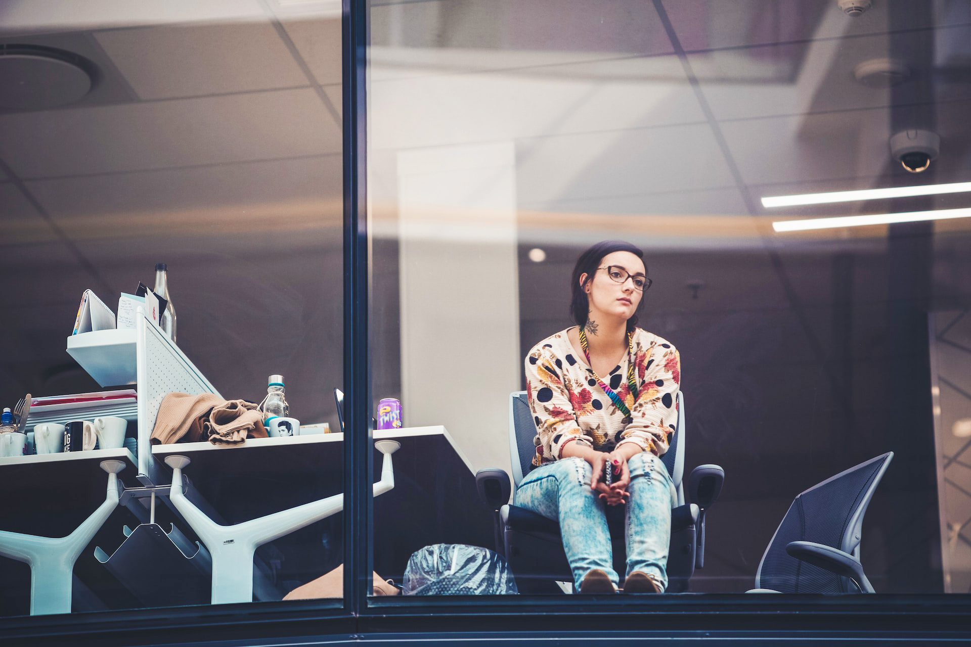 Woman sitting at desk at window thinking about quitting her job