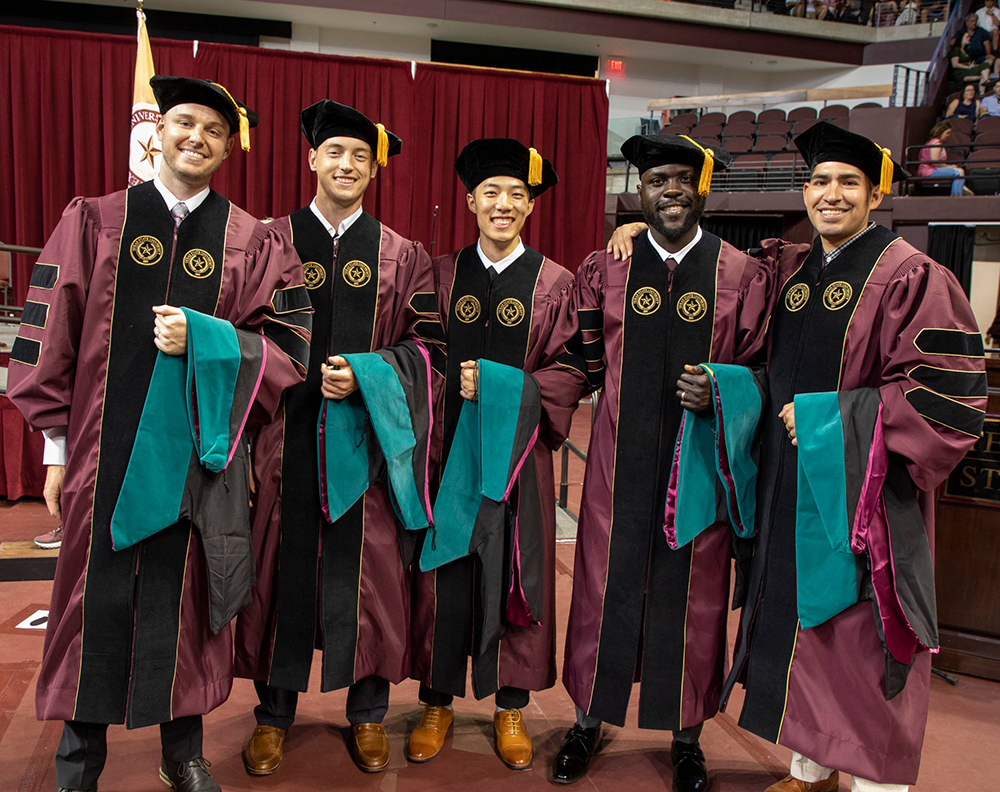 Graduate degree recipients pose