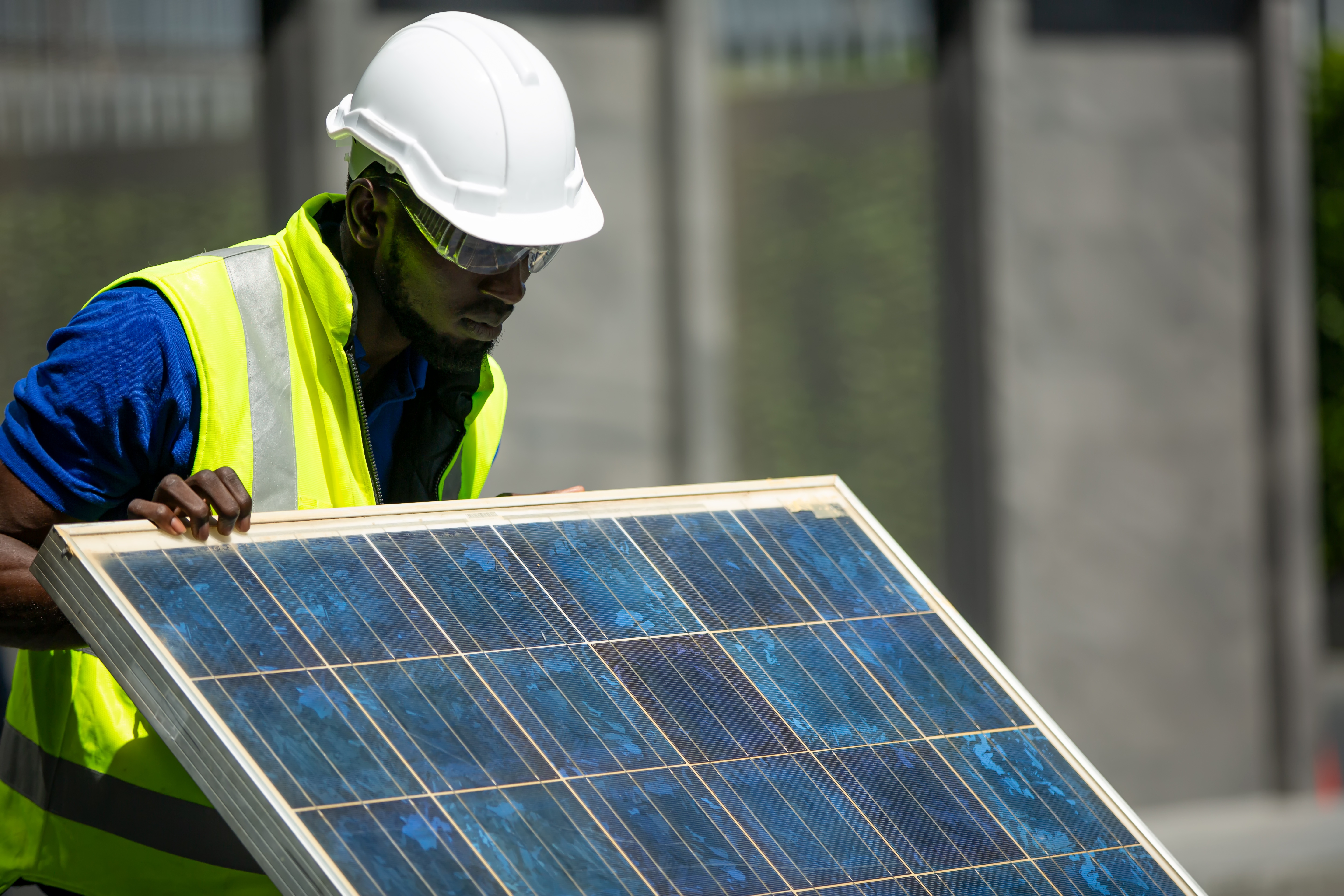 Solar worker lifts panel