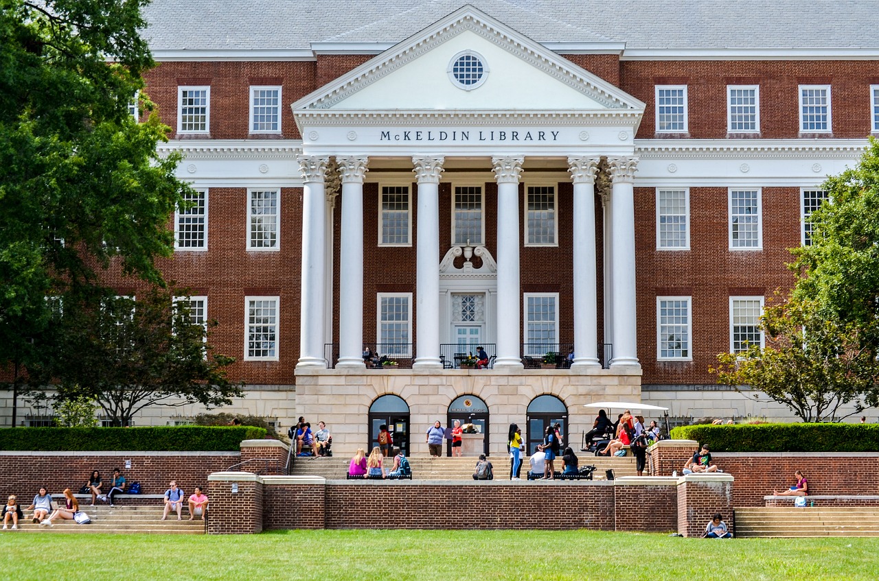 University library exterior, with people gathered around the base