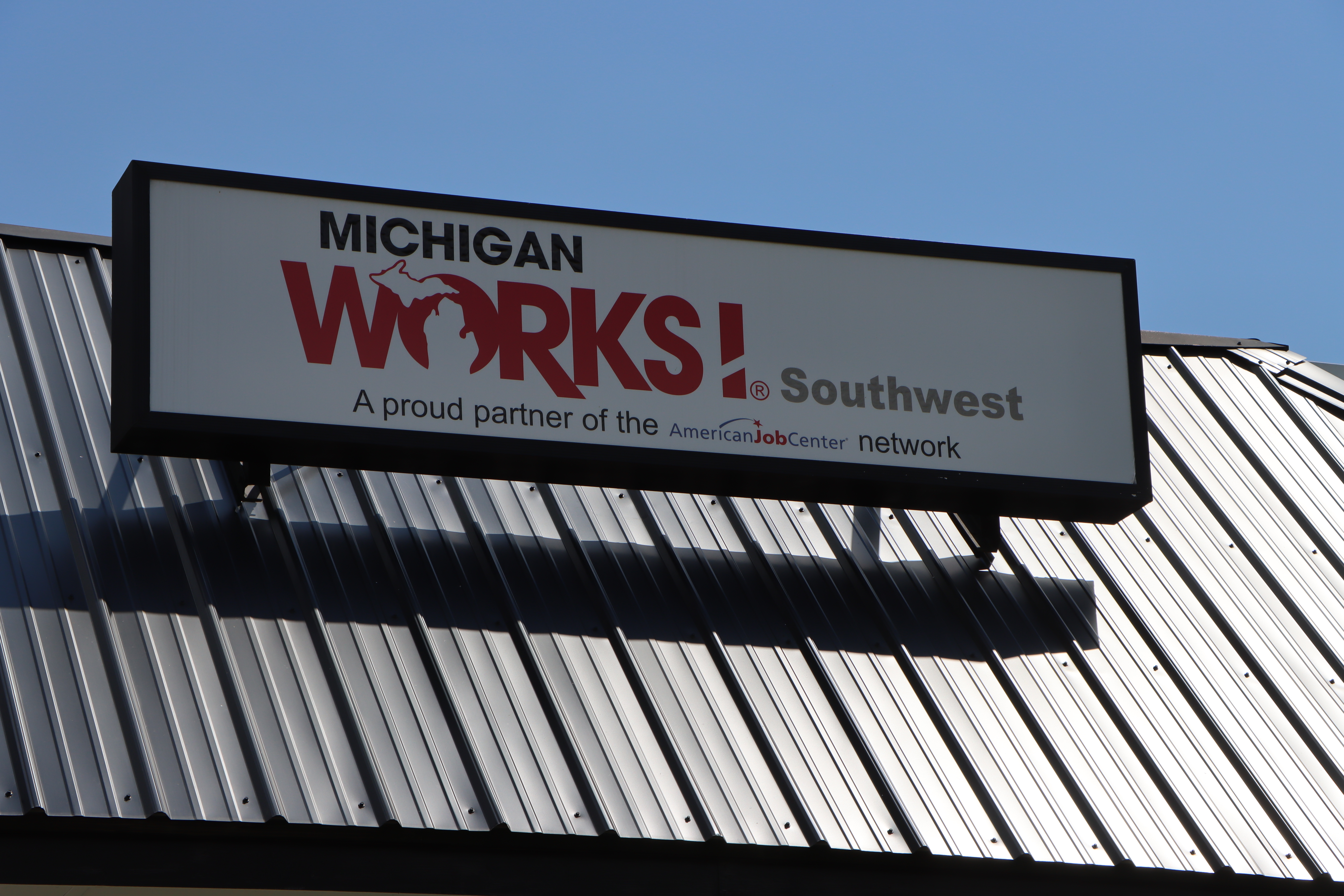 sing on roof of Michigan Works Southwest office
