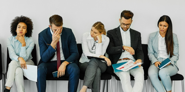Five Stressed Professionals Waiting For An Interview In An Officeby dvatri