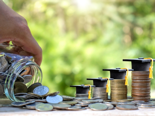Stacks of coins with mortarboard hats