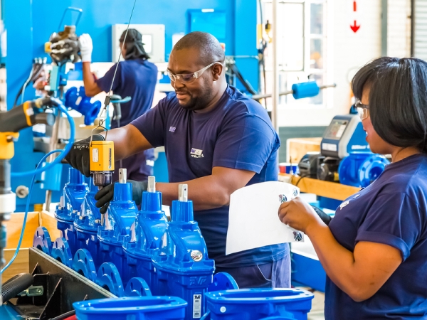 Workers in an industrial valve manufacturing factory