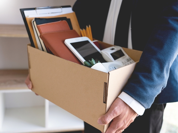 Man carrying box of work belongings