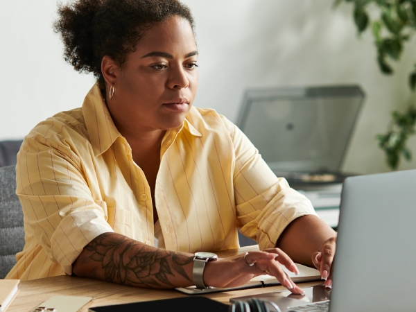 Adult worman working on a lap top computer