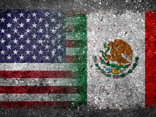 A US flag and a Mexican Flag blend into one another against a grey background,