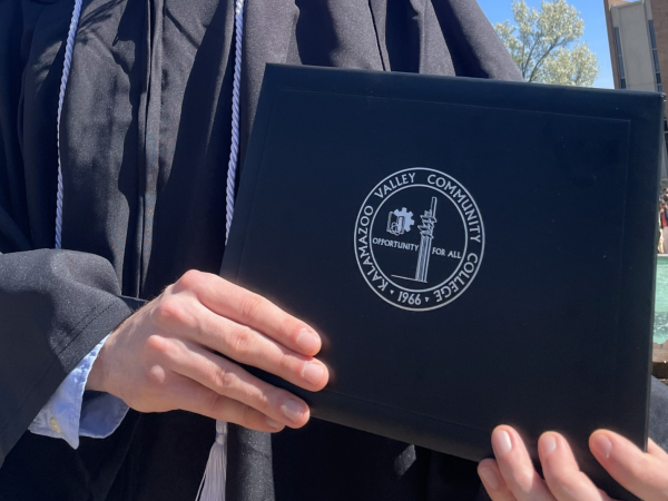 COllege Grad holding a diploma