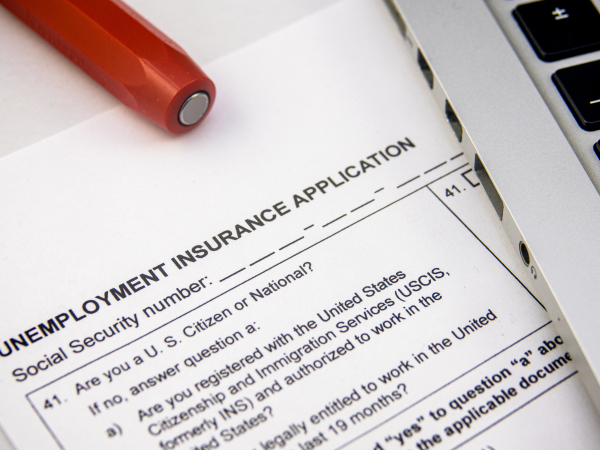 Unemployment Insurance Application with Red Pen and Laptopby mrdoomits
