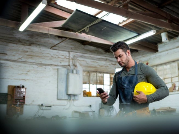Man carrying yellow hard hat