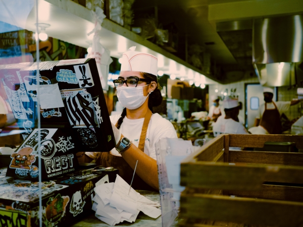 Server wearing COVID mask at register