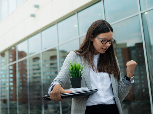 Woman leaving office with possessions after quitting job to take another