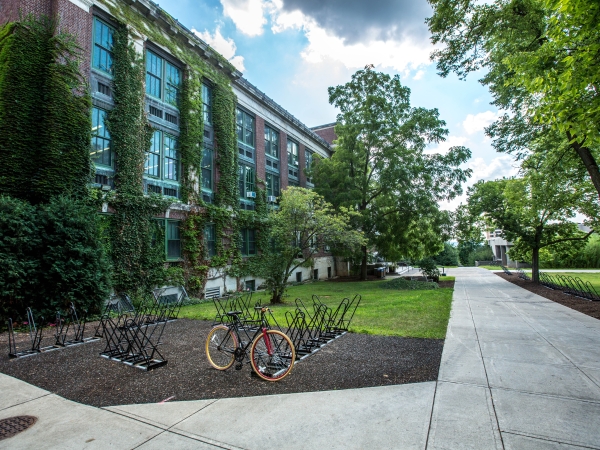 College campus exterior, bike at rack. 