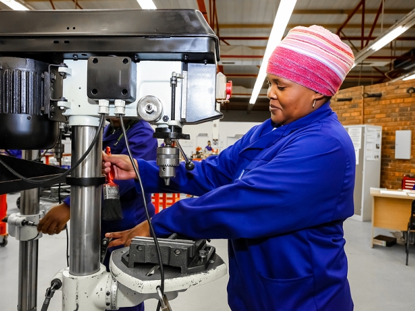 Woman works in machine shop