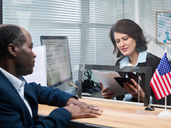 Man and Woman Talking Through Glass in Workplaceby Pressmaster