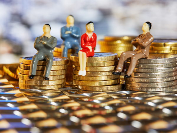Figurines Sitting on Stacks of Gold and Silver Coinsby foodphotoalex
