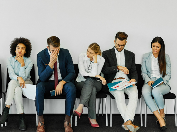Five Stressed Professionals Waiting For An Interview In An Officeby dvatri