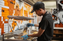 fast food worker preparing french fries