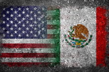 A US flag and a Mexican Flag blend into one another against a grey background,