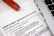 Unemployment Insurance Application with Red Pen and Laptopby mrdoomits